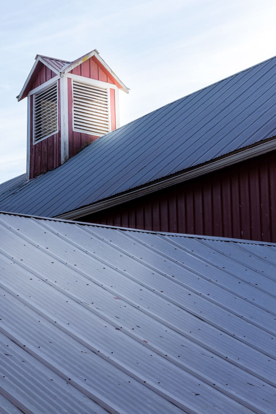 Corrugated metal roofing with visible rows of exposed fasteners