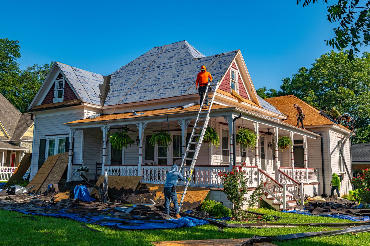 Residential reroofing with exposed sheathing, new underlayment and ground protection
